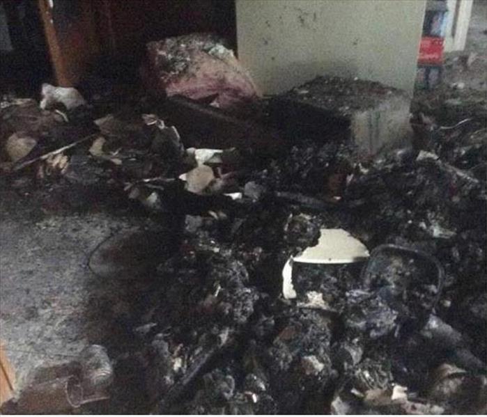 piles of blackened and burnt contents on a floor