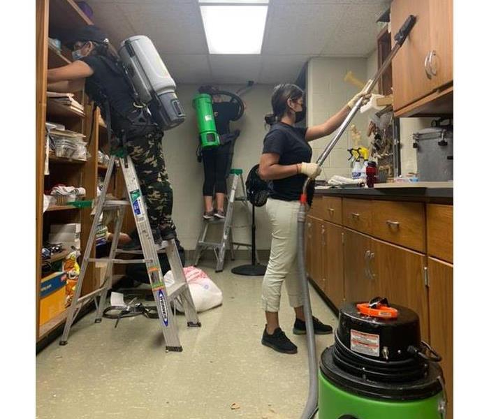 Technicians use portable extractors to clean cabinets, ceilings, and shelving