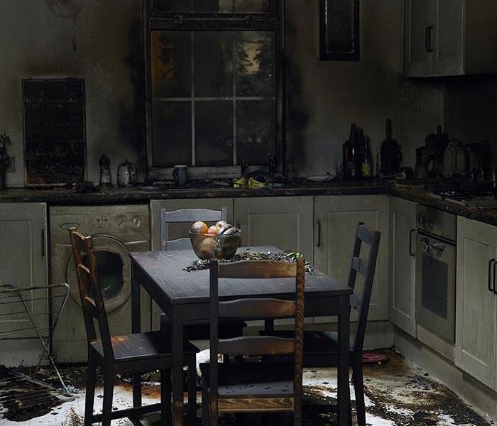 damaged kitchen after a fire and everything is covered in soot