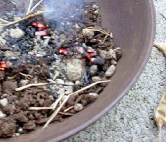 fire smoldering in a pot